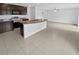 Open concept kitchen with dark wood cabinetry, granite counter tops, and a kitchen island at 8452 Silverbell Loop, Brooksville, FL 34613