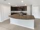 Modern kitchen with granite countertops, stainless steel appliances, and an island with a sink at 8452 Silverbell Loop, Brooksville, FL 34613