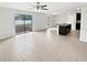 Spacious, open living area with tile floors, ceiling fan, and sliding glass doors leading to the backyard at 8452 Silverbell Loop, Brooksville, FL 34613