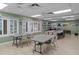 Bright activity room featuring tables, chairs, and ample space, perfect for socializing and hobbies in Timber Oaks at 10820 Hachita Dr, Port Richey, FL 34668