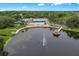 Community clubhouse and a lake with a fountain and a gazebo, offering serene waterfront views and community amenities at 10820 Hachita Dr, Port Richey, FL 34668
