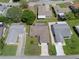 Overhead view of a one-story home, with a spacious yard in a residential area, surrounded by mature trees at 10820 Hachita Dr, Port Richey, FL 34668