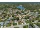Beautiful aerial view of a lakeside residential neighborhood with mature trees and well-maintained homes at 10820 Hachita Dr, Port Richey, FL 34668