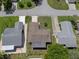 Aerial view of a well-maintained single-story home with a mature lawn, surrounded by neighboring houses at 10820 Hachita Dr, Port Richey, FL 34668