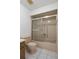 A peach bathtub and toilet are shown, with a shower featuring sliding glass doors at 10820 Hachita Dr, Port Richey, FL 34668