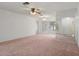 Spacious bedroom with carpet, lighted ceiling fan, and lots of natural light at 10820 Hachita Dr, Port Richey, FL 34668