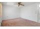 Bedroom featuring neutral carpet, a ceiling fan, and a closet at 10820 Hachita Dr, Port Richey, FL 34668