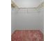 Spacious walk-in closet with shelves and carpeted flooring, offering great storage possibilities at 10820 Hachita Dr, Port Richey, FL 34668
