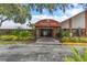 Community clubhouse with covered entrance, offering convenient access to amenities and promoting an active lifestyle at 10820 Hachita Dr, Port Richey, FL 34668