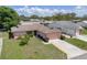 Charming single-story home with attached garage, manicured lawn, and established landscaping on a sunny day at 10820 Hachita Dr, Port Richey, FL 34668