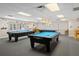 Game room featuring multiple pool tables and lighting, providing a fun and entertaining recreational space for community members at 10820 Hachita Dr, Port Richey, FL 34668