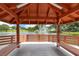 Interior view of a gazebo overlooking a lake with a fountain at 10820 Hachita Dr, Port Richey, FL 34668