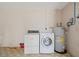 Laundry area featuring a washing machine, dryer, and water heater at 10820 Hachita Dr, Port Richey, FL 34668