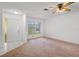 A bright living room features tile floors, a large window, neutral paint, and a ceiling fan at 10820 Hachita Dr, Port Richey, FL 34668