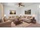 Comfortable living room with plush seating, a ceiling fan, and lovely decorative accents at 10820 Hachita Dr, Port Richey, FL 34668