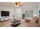 Cozy living room featuring a comfortable beige sectional and modern media center at 10820 Hachita Dr, Port Richey, FL 34668