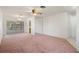 Open-concept living area with a view to adjoining sunroom at 10820 Hachita Dr, Port Richey, FL 34668