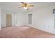 Main bedroom with neutral walls, carpet, ceiling fan, and a window with privacy blinds at 10820 Hachita Dr, Port Richey, FL 34668