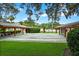 View of two outdoor shuffleboard courts near shaded pavilions at 10820 Hachita Dr, Port Richey, FL 34668