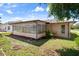View of the sunroom and well-maintained lawn, offering a serene and comfortable space to relax outdoors at 10820 Hachita Dr, Port Richey, FL 34668