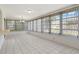 Spacious sunroom with tile flooring, light fixture, and a wall of windows for ample natural light at 10820 Hachita Dr, Port Richey, FL 34668
