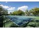 Well-maintained tennis court with green and blue surface at 10820 Hachita Dr, Port Richey, FL 34668