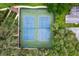Aerial view of two blue tennis courts surrounded by trees at 10820 Hachita Dr, Port Richey, FL 34668