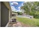 The backyard features a community pool surrounded by a white fence and mature trees at 11304 Cayman Key Ave # 2, Tampa, FL 33624
