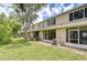 Green backyard featuring a row of houses with screened patios, creating a perfect blend of comfort and privacy at 11304 Cayman Key Ave # 2, Tampa, FL 33624