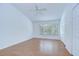Well-lit bedroom featuring hardwood flooring, large window, and closet at 11304 Cayman Key Ave # 2, Tampa, FL 33624