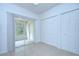 Bright bedroom featuring tile flooring, sliding glass door to the patio, and closet space at 11304 Cayman Key Ave # 2, Tampa, FL 33624