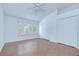 Bright bedroom features wood floors, a ceiling fan, large window, and double door closet at 11304 Cayman Key Ave # 2, Tampa, FL 33624