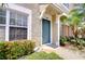 Close-up of a blue front door with manicured landscaping at 11304 Cayman Key Ave # 2, Tampa, FL 33624