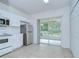 This kitchen has white cabinets, stainless steel appliances, and sliding door access to the patio at 11304 Cayman Key Ave # 2, Tampa, FL 33624