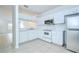 Bright kitchen featuring white cabinets, stainless steel appliances, and tile flooring at 11304 Cayman Key Ave # 2, Tampa, FL 33624