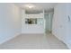 Bright living room showcasing tile flooring and a pass-through to the kitchen at 11304 Cayman Key Ave # 2, Tampa, FL 33624