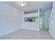 Bright living room showcasing tile flooring and a pass-through to the kitchen at 11304 Cayman Key Ave # 2, Tampa, FL 33624