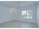 Bright living room with large window and fan, featuring tile flooring at 11304 Cayman Key Ave # 2, Tampa, FL 33624