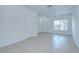 Bright living room featuring tile flooring and an exterior door at 11304 Cayman Key Ave # 2, Tampa, FL 33624
