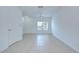 Well-lit living room featuring tile flooring and an exterior door at 11304 Cayman Key Ave # 2, Tampa, FL 33624