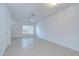 Well-lit living room featuring tile flooring and a ceiling fan at 11304 Cayman Key Ave # 2, Tampa, FL 33624