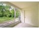Screened-in patio with a view of the backyard and surrounding greenery at 11304 Cayman Key Ave # 2, Tampa, FL 33624