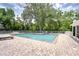 Inviting community pool area with lounge chairs and lush greenery offering a tranquil and refreshing experience at 11304 Cayman Key Ave # 2, Tampa, FL 33624