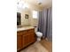 Neutral bathroom features a tub-shower, wood vanity and tile floors at 11416 Wellman Dr, Riverview, FL 33578