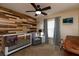 A neutral bedroom with a wood pallet wall, carpeted floor, and a crib at 11416 Wellman Dr, Riverview, FL 33578