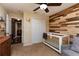 Cute Bedroom features a wood accent wall and comfortable furnishings at 11416 Wellman Dr, Riverview, FL 33578