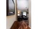Stylish entryway with gleaming wood floors, a mirror, and a glimpse into the living area at 11416 Wellman Dr, Riverview, FL 33578