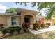 Inviting home entrance showcasing a covered porch and colorful landscaping at 11416 Wellman Dr, Riverview, FL 33578