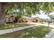 Charming home with a well-kept lawn, large trees, and long driveway at 11416 Wellman Dr, Riverview, FL 33578