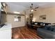 Inviting living room boasts hardwood floors and comfortable dark furnishings at 11416 Wellman Dr, Riverview, FL 33578
